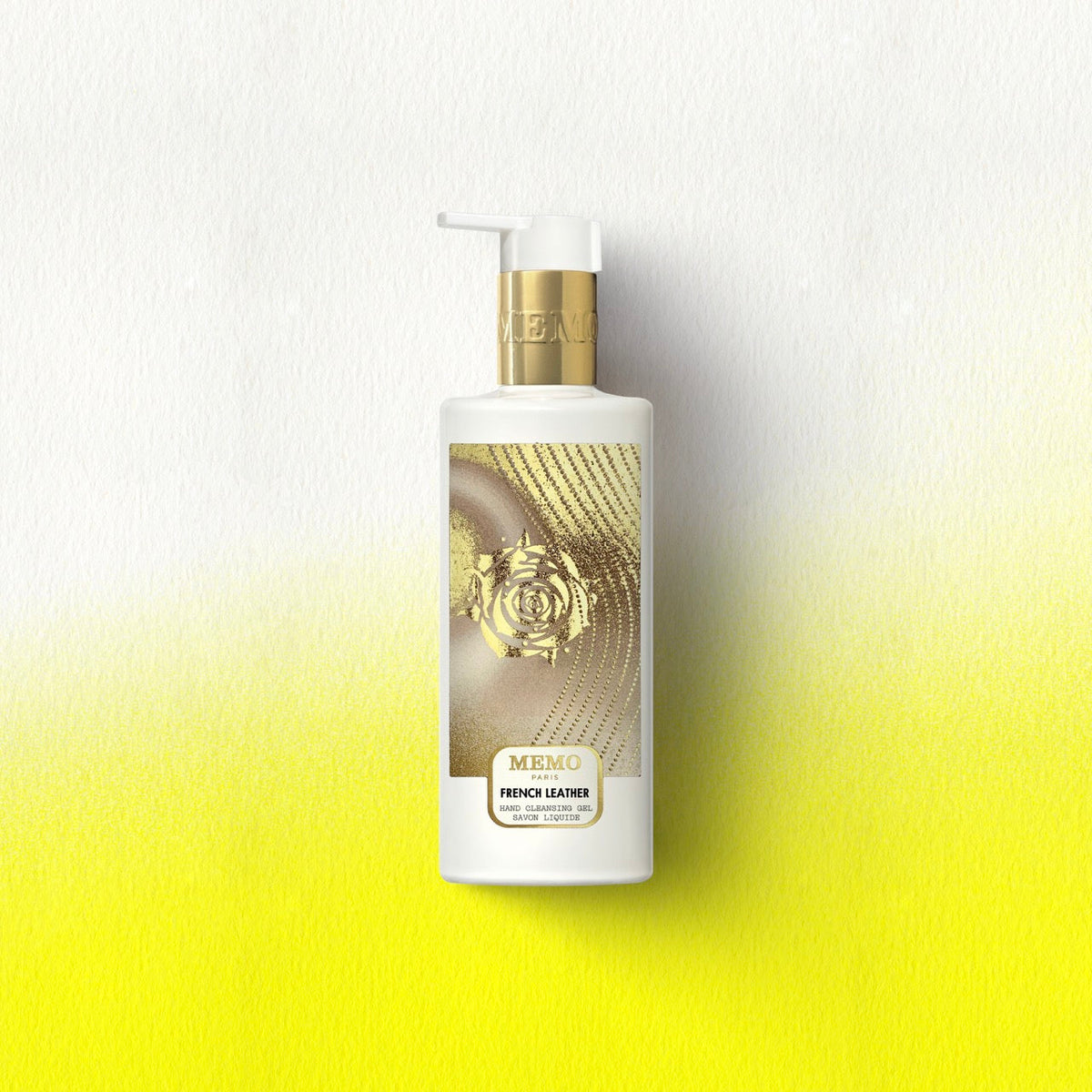 White bottle of memo paris french leather liquid hand soap with gold pump and embossed rose label design