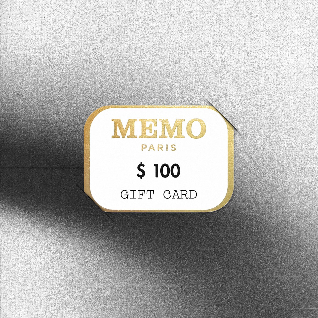A white and gold memo paris gift card with elegant typography and 100 denomination perfect for fragrant treasures offer