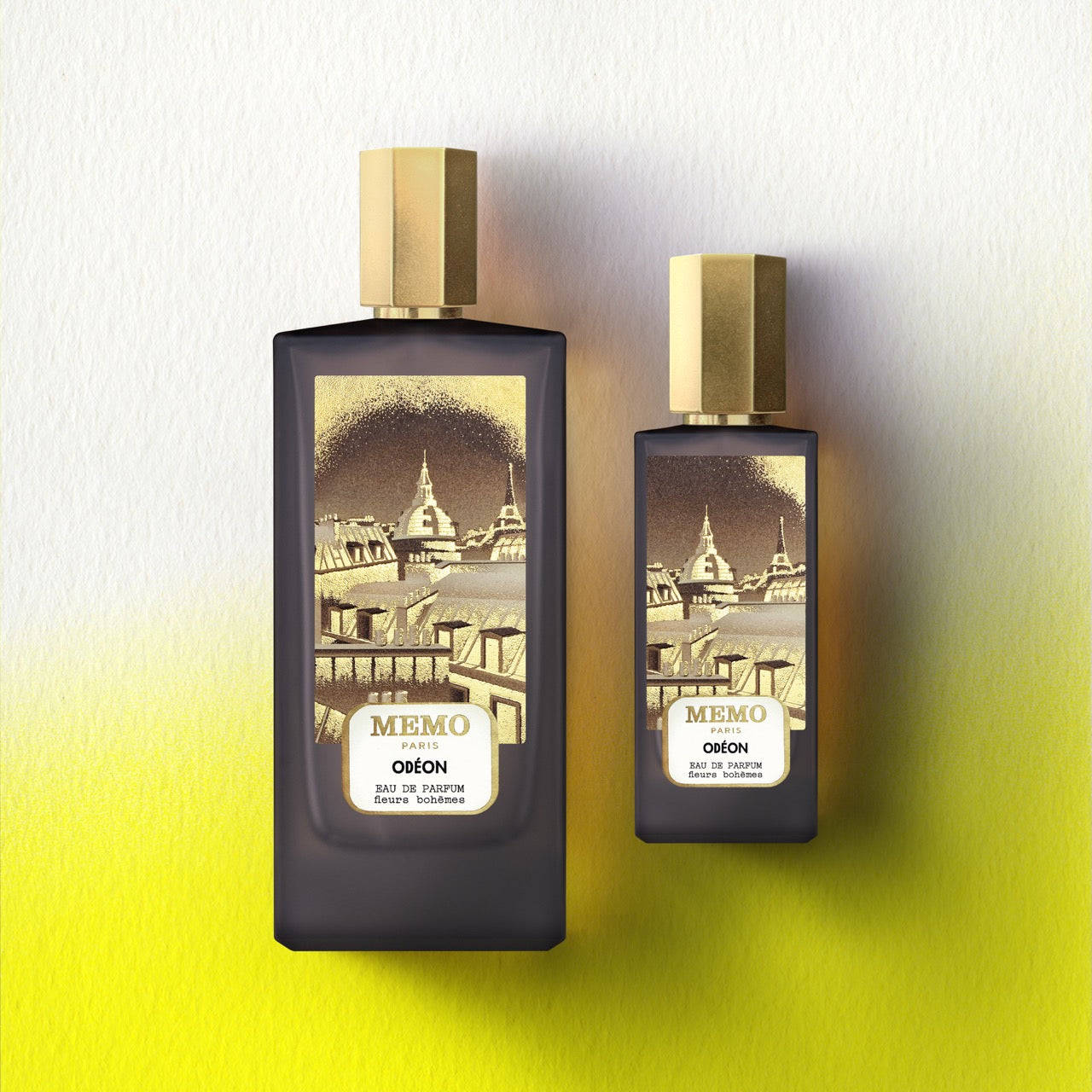 Two elegant dark glass perfume bottles with gold caps from memo paris signature duet odéon featuring tonka bean notes — vue alternative
