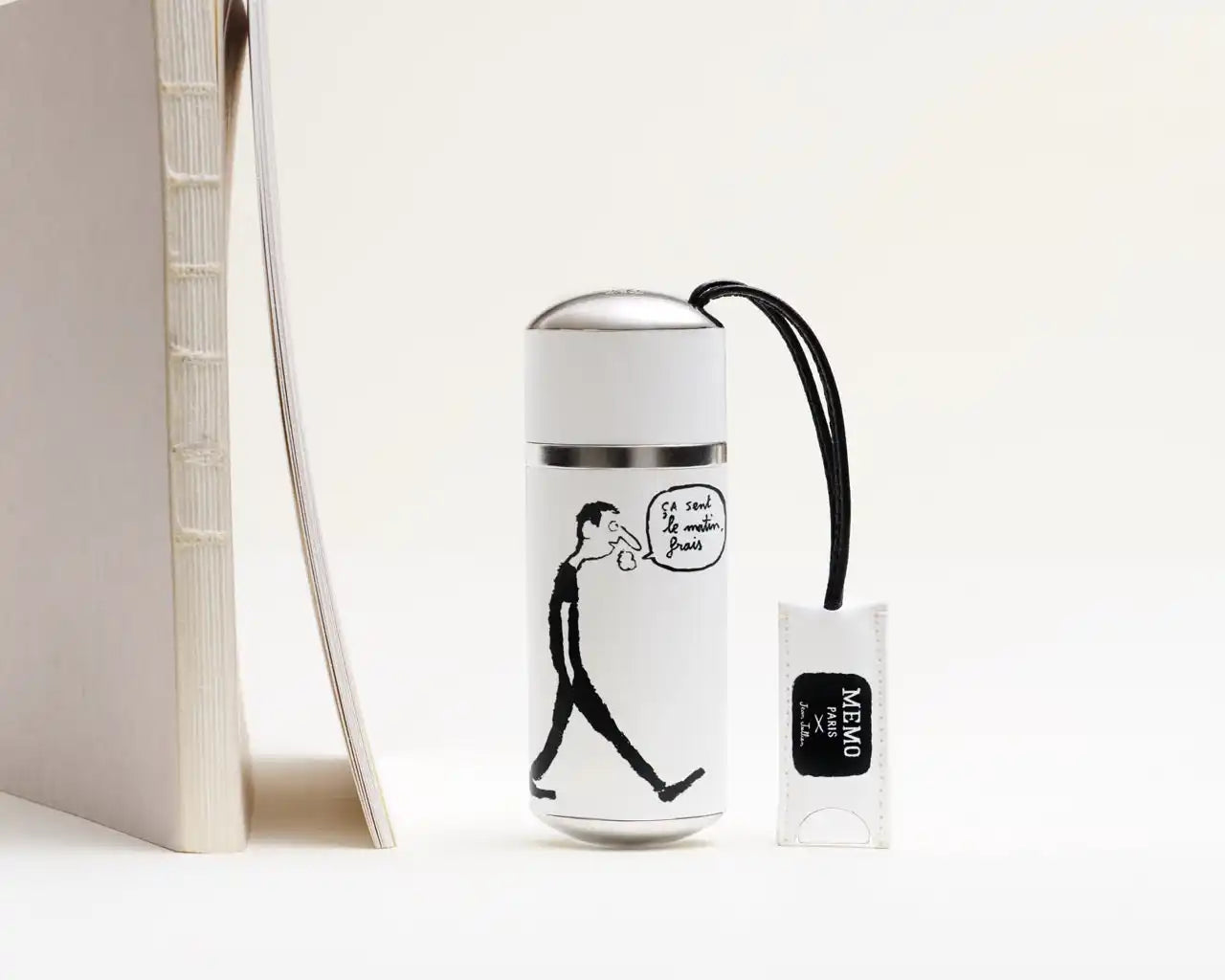 A white insulated travel mug with a black line drawing of a man walking and a speech bubble.