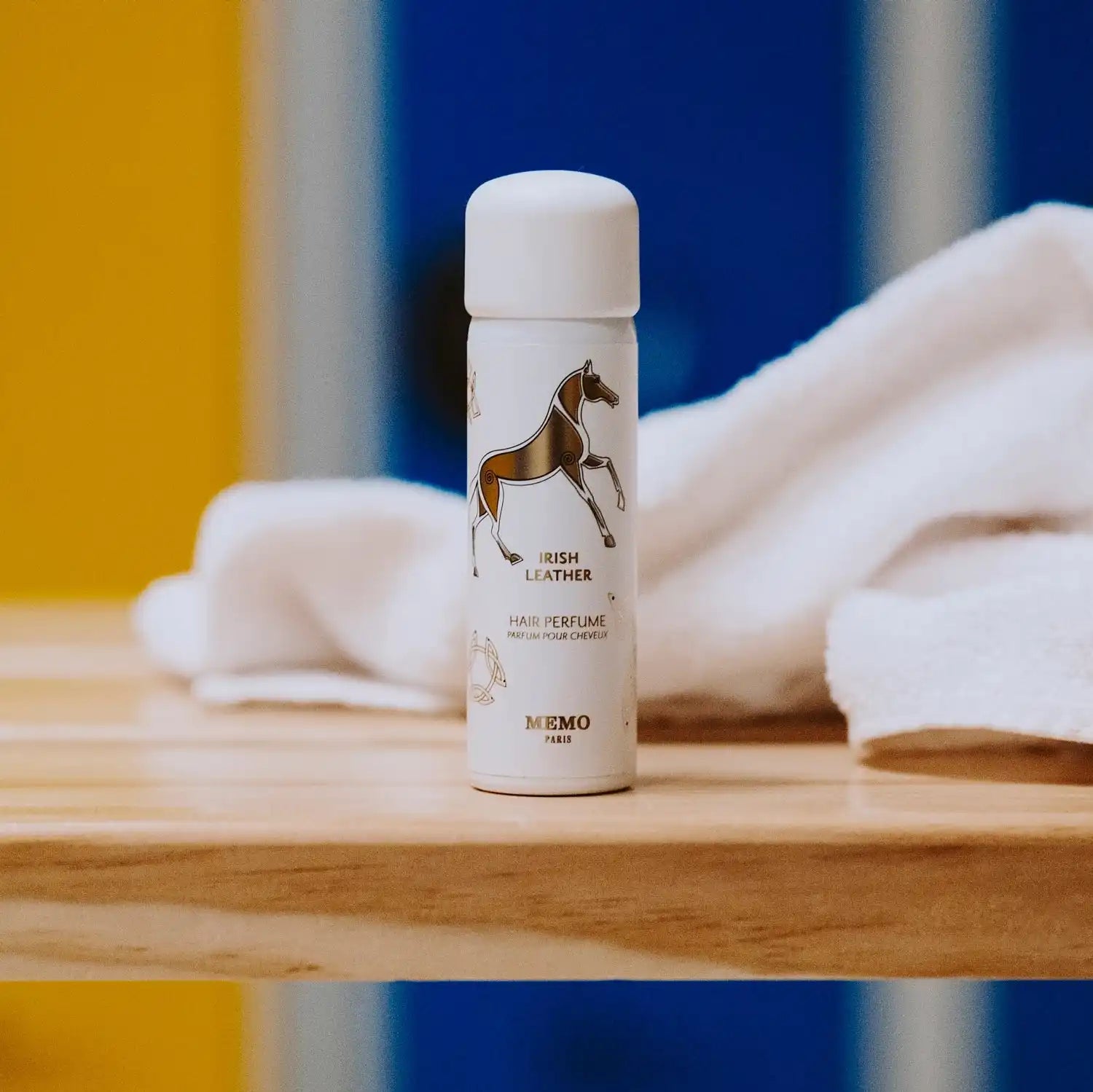A cylindrical white bottle with a brown horse illustration.