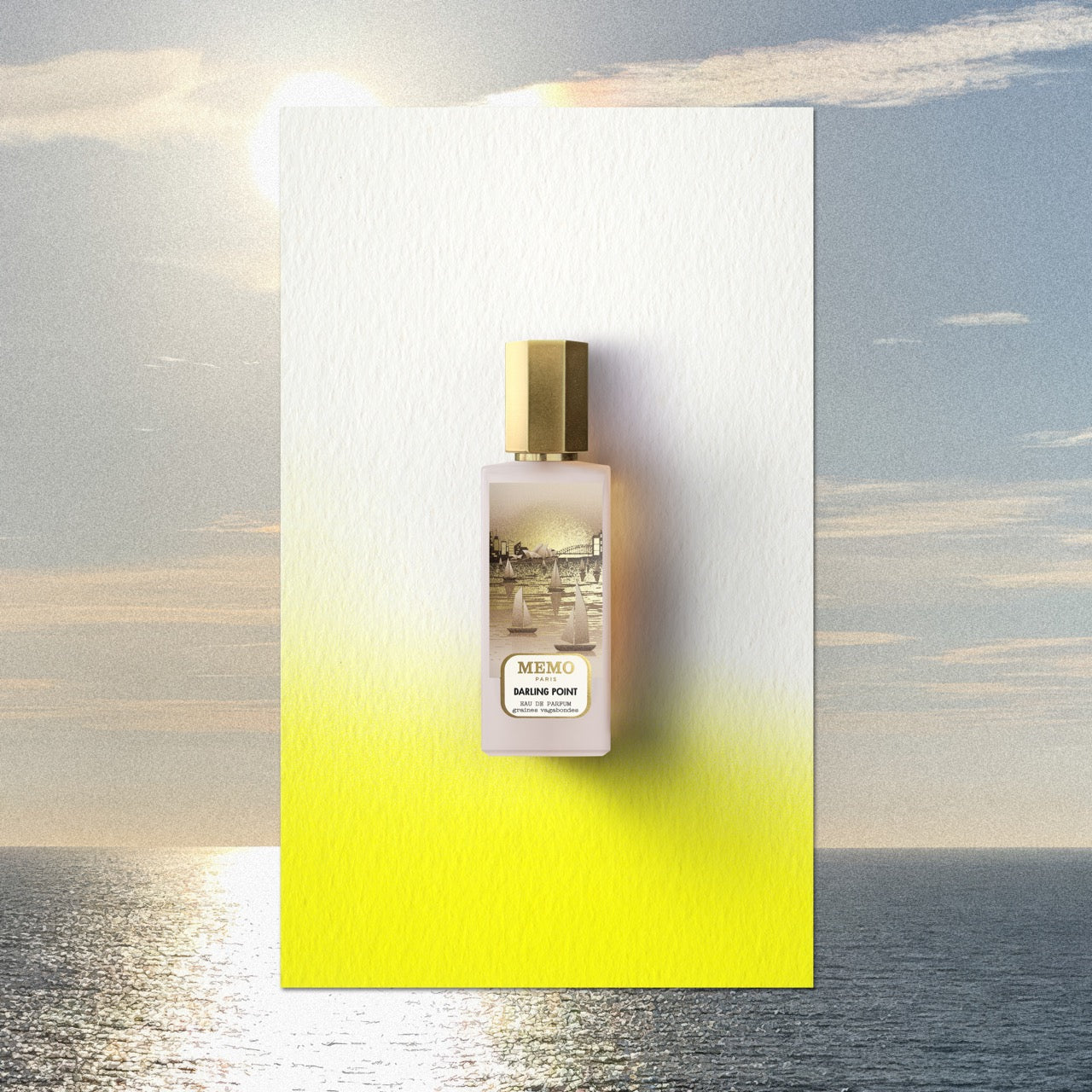 A sleek frosted glass bottle of memo paris darling point eau de parfum with a gold cap and illustrated label — vue alternative