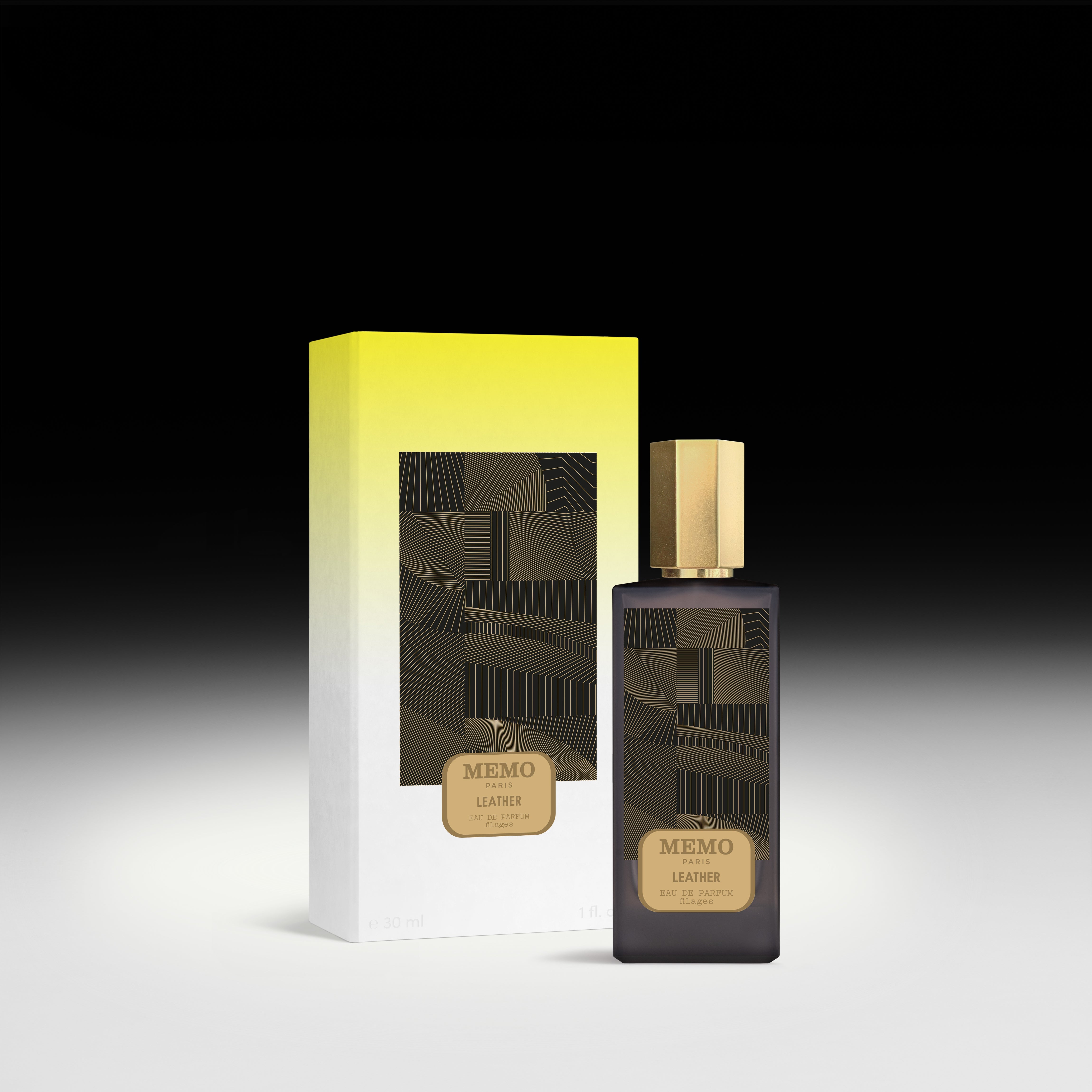 Dark glass bottle with gold cap and geometric label of memo paris essences filages filages eau leather fragrance