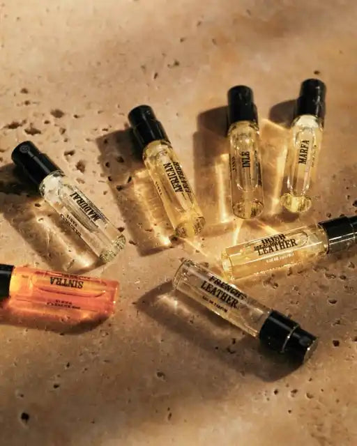Various fragrance vials with black caps.