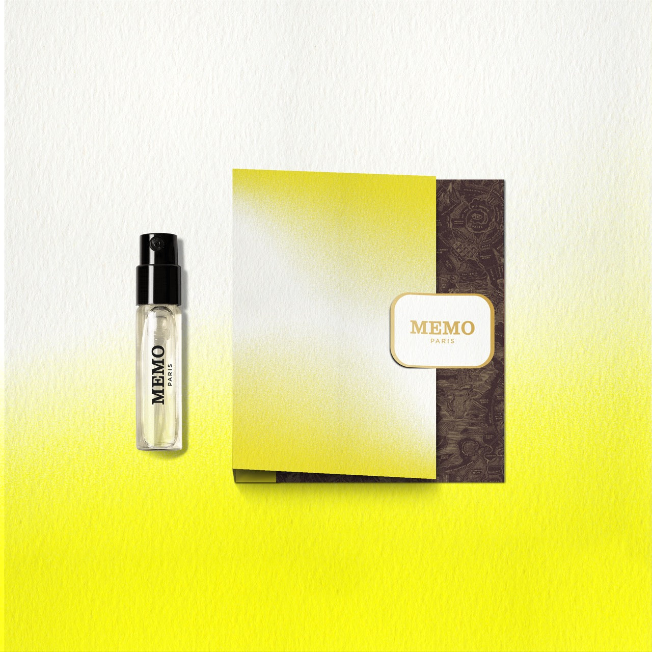 A sleek transparent glass perfume vial with black spray nozzle and memo paris branding in the new destination collection