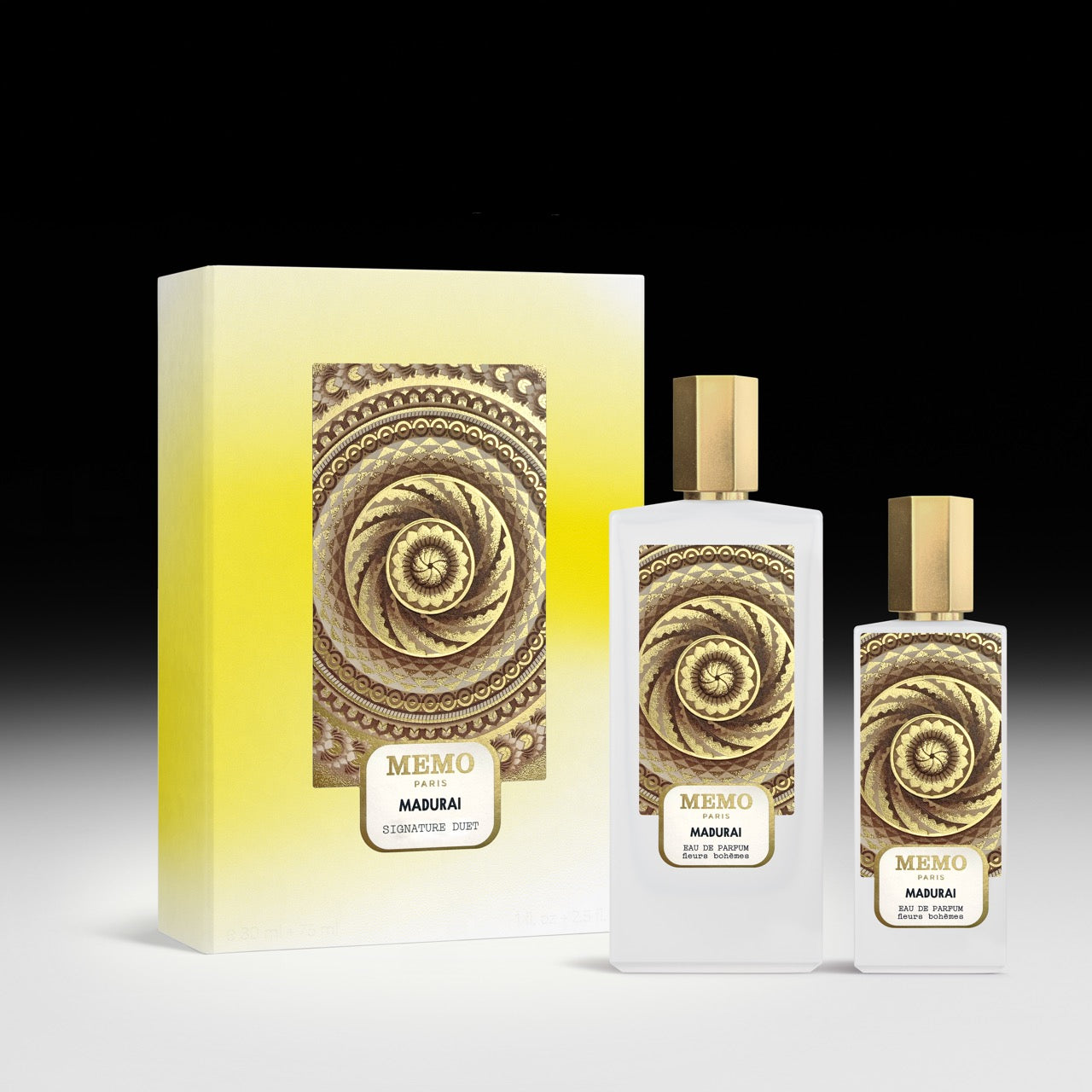 Elegant white glass perfume bottles with gold caps and spiral designs beside a gradient yellow box for signature duet madurai 30ml 75ml