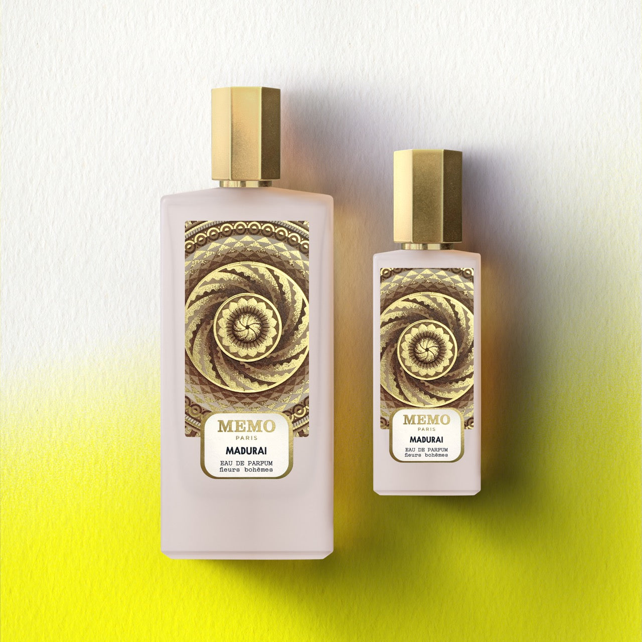 Two elegant translucent pink perfume bottles with gold caps and intricate spiral labels from memo paris signature duet madurai — vue alternative