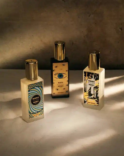 Three distinct perfume bottles with unique label designs.